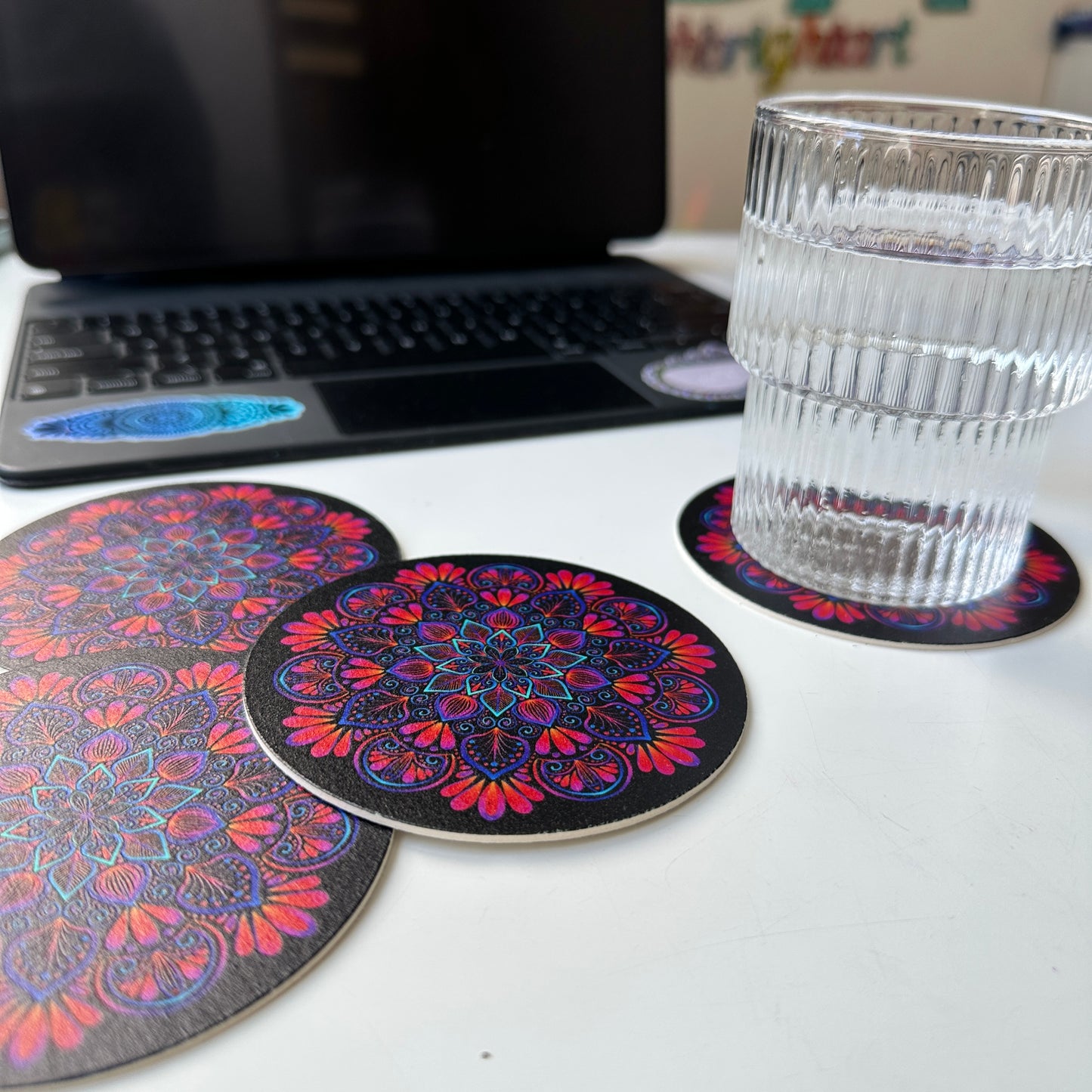 black background and colorful mandala coaster